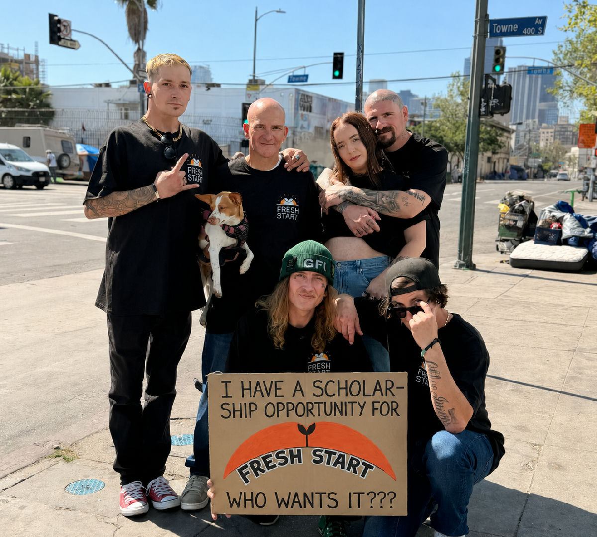 The Fresh Start team on the street holding a sign offering a scholarship opportunity