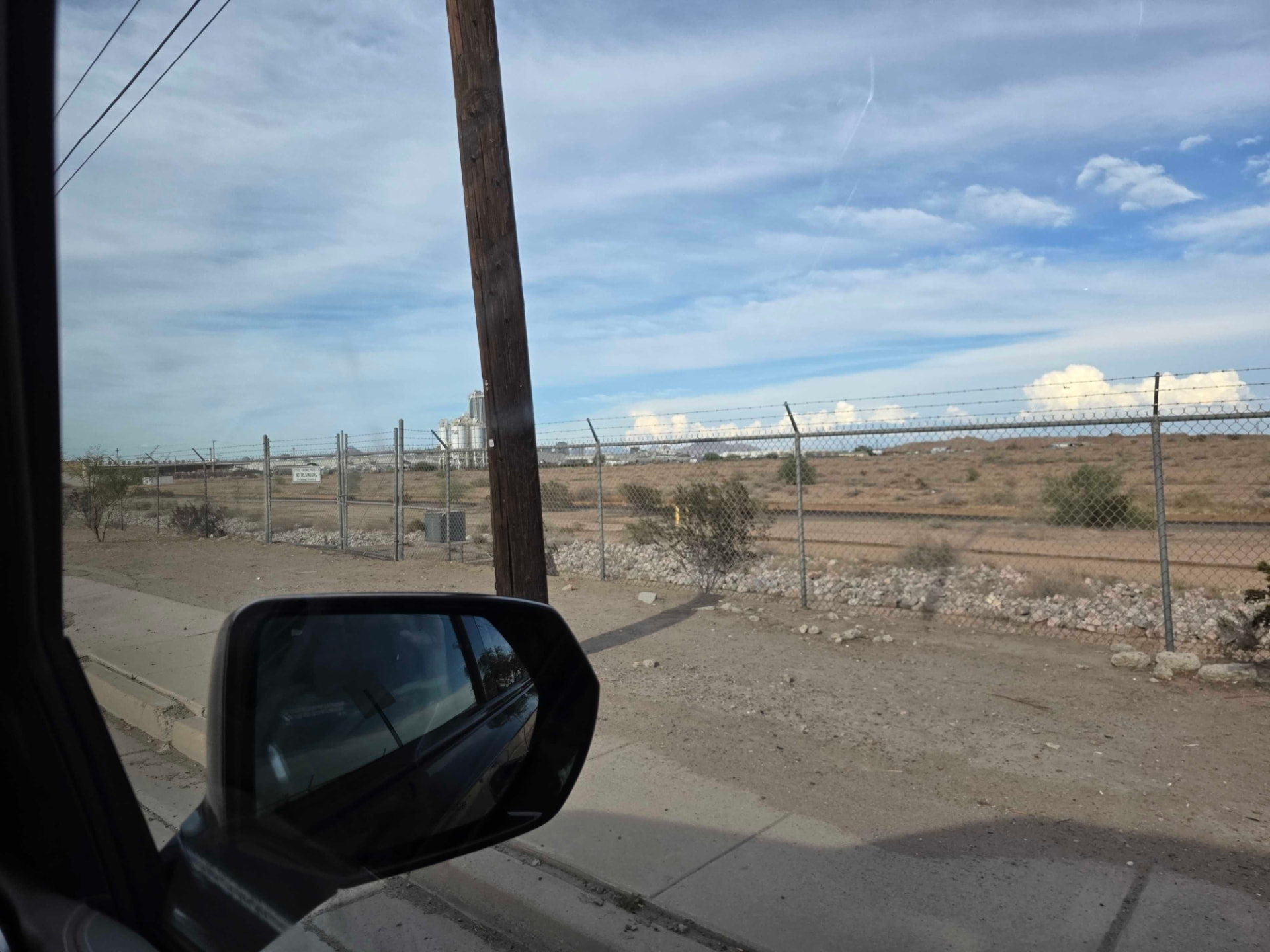 Open desert land seen from a car window outside Phoenix